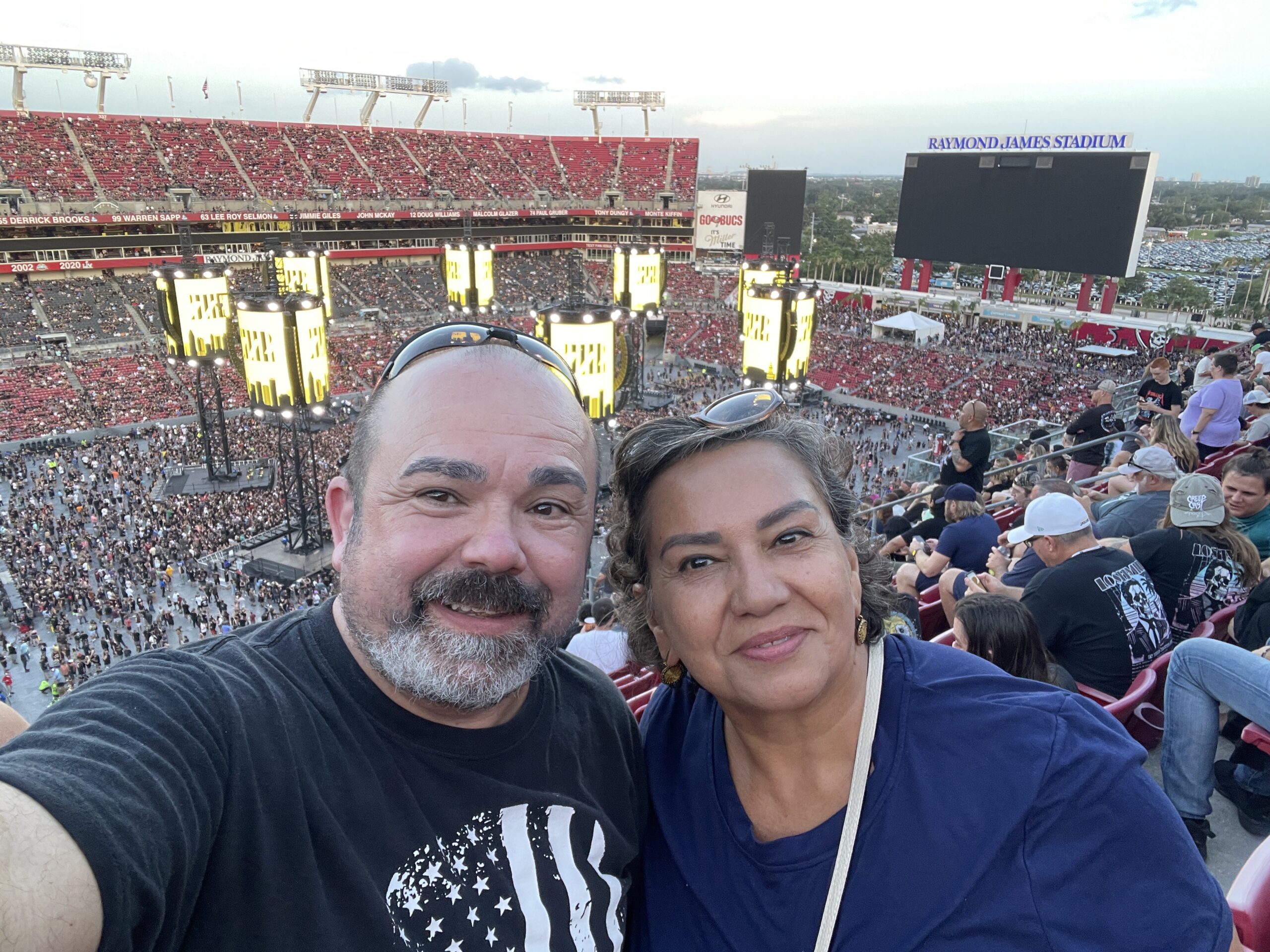 Roger Magalhaes, a window treatment business expert, and his wife at a Metallica concert, finding inspiration for industry success.