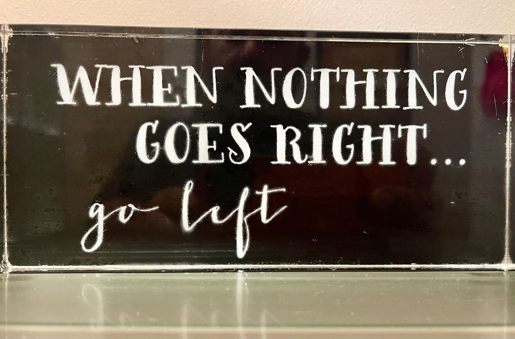 Sign reading "when nothing goes right, go left" — inspiration for window covering business success and installer motivation.